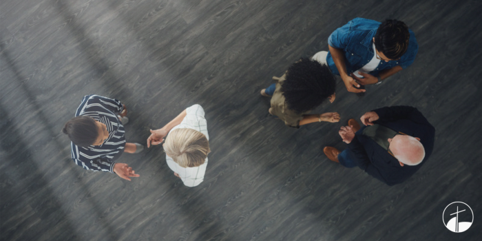 adults in a room mingling.